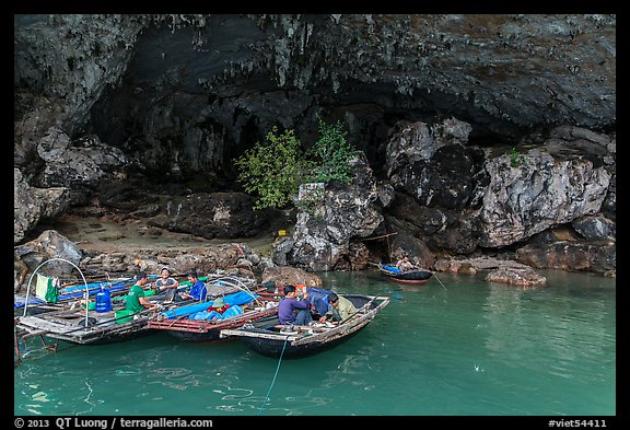 Fishermen anchor eating breakfast in cave. Halong Bay, Vietnam (color)