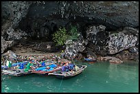 Fishermen anchor eating breakfast in cave. Halong Bay, Vietnam (color)