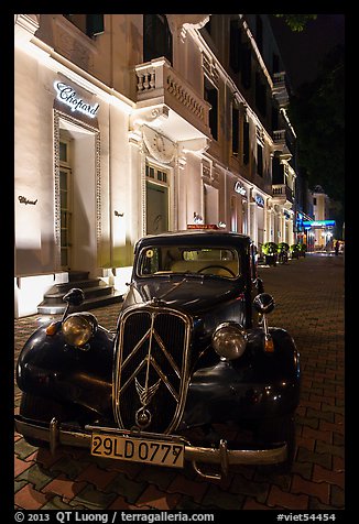 Vintage car in front of Metropole hotel at night. Hanoi, Vietnam