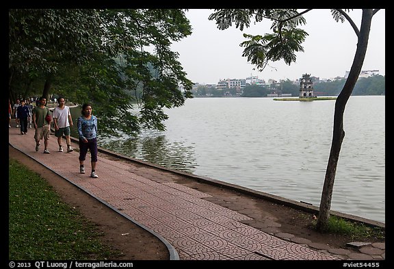 Walking for exercise around Hoang Kiem Lake at dawn. Hanoi, Vietnam (color)