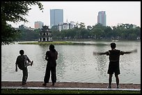 People exercising in front of Turtle Tower, Hoang Kiem Lake. Hanoi, Vietnam (color)