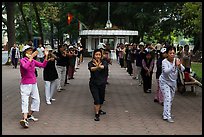 Women practising Tai Chi on shores of Hoang Kiem Lake. Hanoi, Vietnam (color)