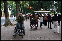 Elderly women pushing their wheelchairs while walking for exercise. Hanoi, Vietnam (color)
