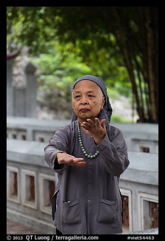 Elderly woman doing Tai Chi moves. Hanoi, Vietnam (color)