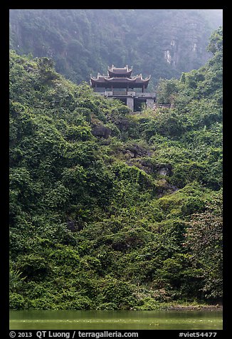 Temple perched on lush hill, Trang An. Ninh Binh,  Vietnam