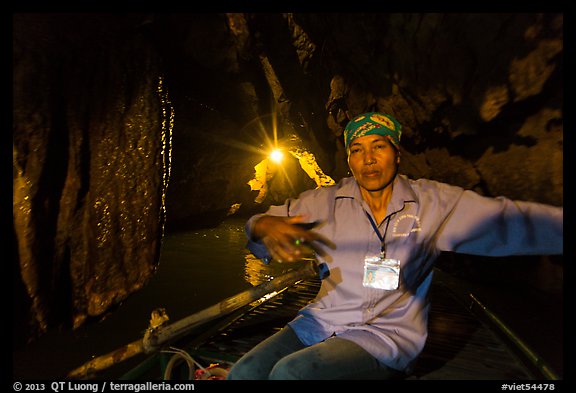 Woman boater in narrow cave passage, Trang An. Ninh Binh,  Vietnam (color)