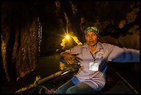 Woman boater in narrow cave passage, Trang An. Ninh Binh,  Vietnam (color)