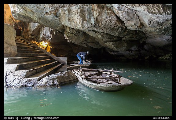 Man readyning a boat inside cave, Trang An. Ninh Binh,  Vietnam