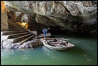 Man readyning a boat inside cave, Trang An. Ninh Binh,  Vietnam (color)