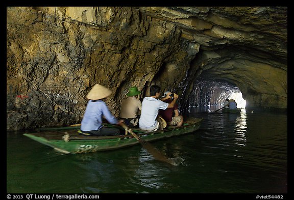 Boat rowed inside grotto passage, Trang An. Ninh Binh,  Vietnam (color)