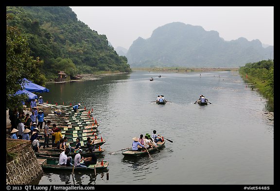 Groups leaving wharf on boats, Trang An. Ninh Binh,  Vietnam (color)