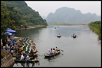 Groups leaving wharf on boats, Trang An. Ninh Binh,  Vietnam (color)