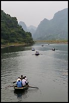 Boats in karstic lanscape of steep cliffs, Trang An. Ninh Binh,  Vietnam ( color)