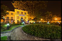 Public garden and French-area building at night. Hanoi, Vietnam (color)