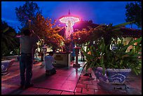 Men pray at outside Phung Son Pagoda at night, district 11. Ho Chi Minh City, Vietnam (color)