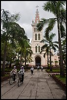 Students biking past Cho Quan Church, district 11. Ho Chi Minh City, Vietnam ( color)