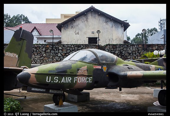 Warplane and wall with barbed wire, War Remnants Museum, district 3. Ho Chi Minh City, Vietnam (color)