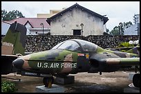 Warplane and wall with barbed wire, War Remnants Museum, district 3. Ho Chi Minh City, Vietnam ( color)