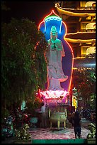 Praying outside Quoc Tu Pagoda at night, district 10. Ho Chi Minh City, Vietnam (color)