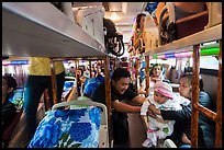 Couple passing baby on sleeper bus. Vietnam ( color)