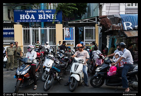 Parents waiting to pick up children in front of school. Ho Chi Minh City, Vietnam (color)