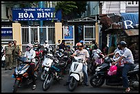 Parents waiting to pick up children in front of school. Ho Chi Minh City, Vietnam