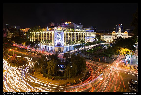 Traffic circle with light trails, Rex Hotel and City Hall. Ho Chi Minh City, Vietnam (color)
