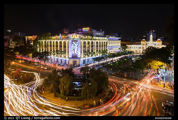 Traffic circle with light trails, Rex Hotel and City Hall. Ho Chi Minh City, Vietnam