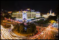Traffic circle with light trails, Rex Hotel and City Hall. Ho Chi Minh City, Vietnam (color)