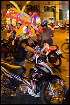 Man with coiffe of balloons, Christmas Eve. Ho Chi Minh City, Vietnam (color)