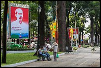 Family chatting with vendor in park. Ho Chi Minh City, Vietnam (color)