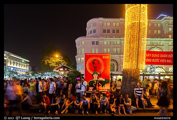 Revellers sitting on street, New Year eve. Ho Chi Minh City, Vietnam