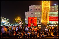 Revellers sitting on street, New Year eve. Ho Chi Minh City, Vietnam ( color)