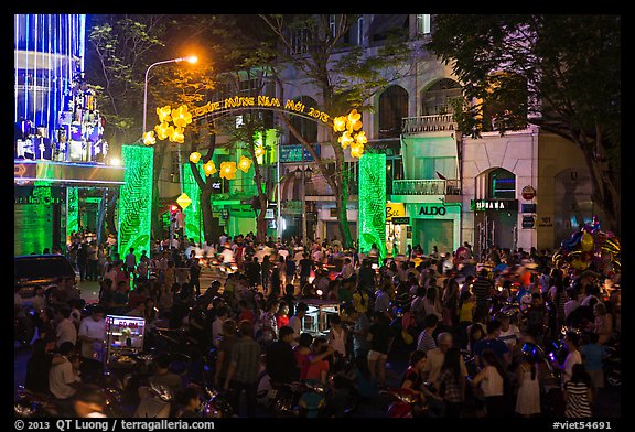 Crowds on street at night, New Year eve. Ho Chi Minh City, Vietnam (color)