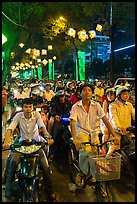 Street packed with motorbikes and bicycle riders at night. Ho Chi Minh City, Vietnam ( color)