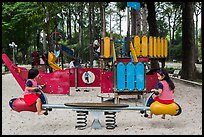 Girls with matching outfits on playground, Van Hoa Park. Ho Chi Minh City, Vietnam ( color)