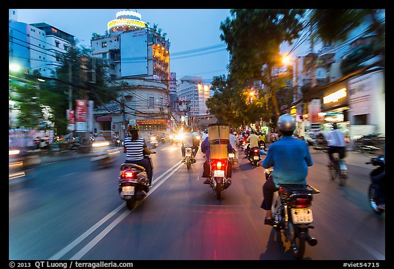 View from middle of street traffic at dusk. Ho Chi Minh City, Vietnam