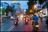 View from middle of street traffic at dusk. Ho Chi Minh City, Vietnam (color)