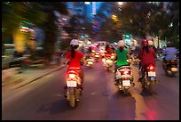 Blurry view from middle of street traffic at night. Ho Chi Minh City, Vietnam (color)