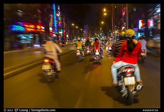 Riders view of motorcycle traffic at night. Ho Chi Minh City, Vietnam