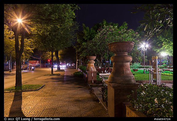 Sidewalk and park at night. Ho Chi Minh City, Vietnam (color)