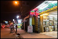 Stores selling pictures at night. Ho Chi Minh City, Vietnam (color)