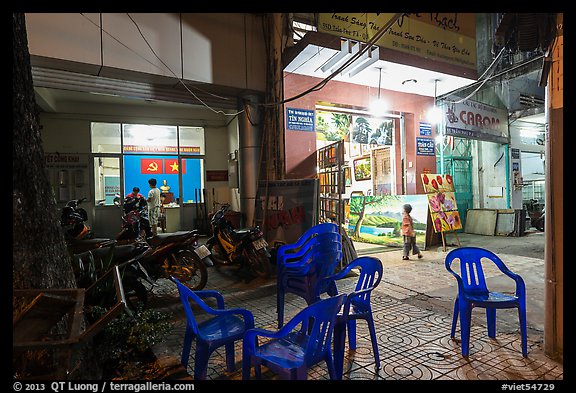 Communist party office and store selling images at night. Ho Chi Minh City, Vietnam (color)