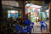 Communist party office and store selling images at night. Ho Chi Minh City, Vietnam