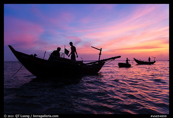 Fishermen on boats at sunset. Mui Ne, Vietnam