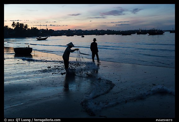 Woman collecting fishing net at dawn. Mui Ne, Vietnam (color)