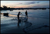 Woman collecting fishing net at dawn. Mui Ne, Vietnam ( color)