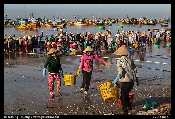 Women carrying baskets with shells. Mui Ne, Vietnam (color)