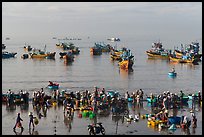 View from above of fishermen, vendors, and fishing fleet. Mui Ne, Vietnam (color)