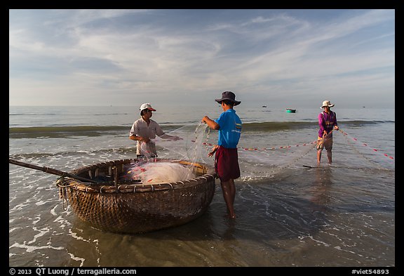 Picture/Photo: Fishermen folding fishing net into coracle boat